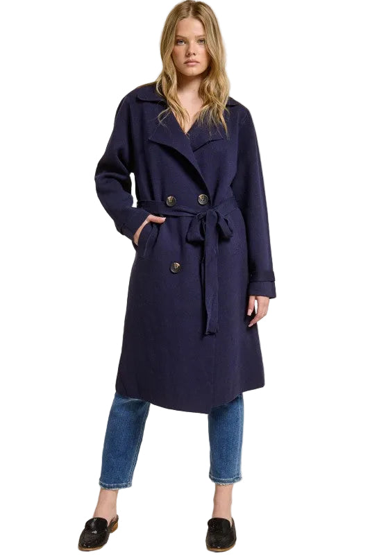 Model wearing a navy blue Trestles Clothing Company Beckham midi sweater coat with a tie belt over jeans